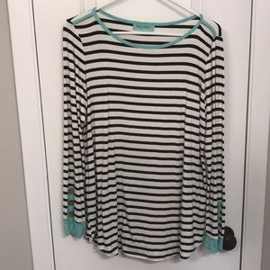 Striped top with turquoise and button cuffs.